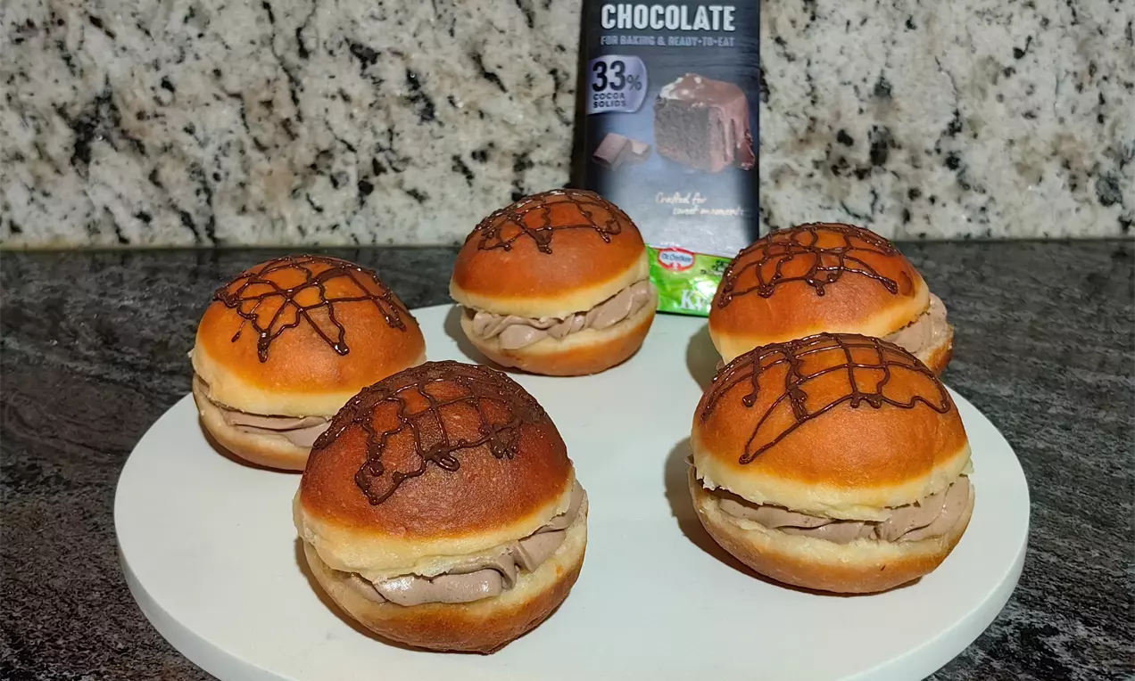 Mehki domači krofi, polnjeni z bogato čokoladno kremo, so popolna kombinacija rahlega testa in svilnatega nadeva.